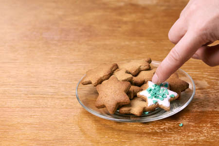 Ginger biscuit decoration. White glaze. Glass plate.の写真素材