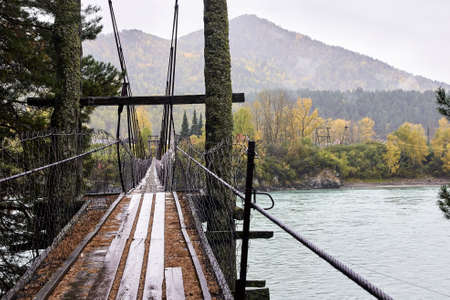 Old bridge. Mountain river. Autumn landscape.の写真素材