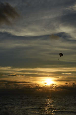 Parachute. Free flight. Sunset at sea.の写真素材