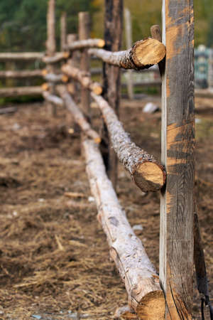 Wooden fence. Three logs. Countryside.の写真素材