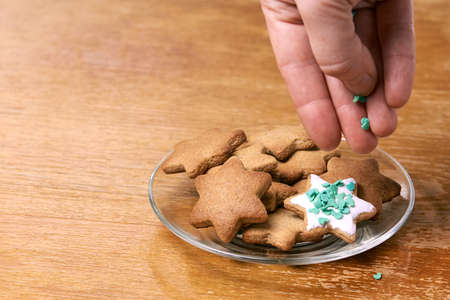 Ginger biscuit decoration. White glaze. Glass plate.の写真素材