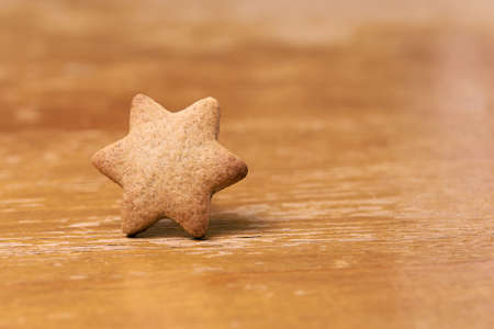 Gingerbread Cookie. Shape star. Brown background.の写真素材
