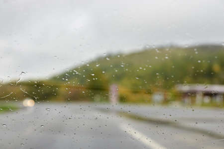 Through glass. Rain drops. Blurred Background.