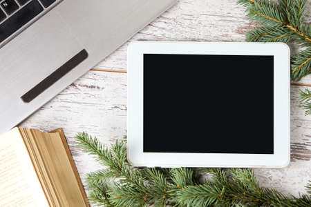 Computer tablet. Green spruce branch. Notebook.の写真素材