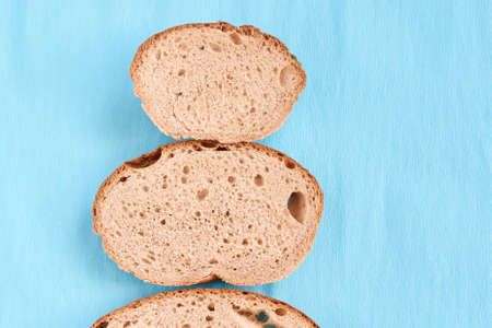 Blue background. Three slices  bread. Unusual tree.の写真素材