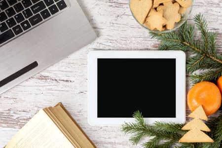 Notebook. Computer tablet. Gingerbread Cookie. Bright mandarins.の写真素材