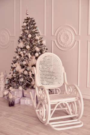 Christmas tree. White armchair. Bright interior.の写真素材
