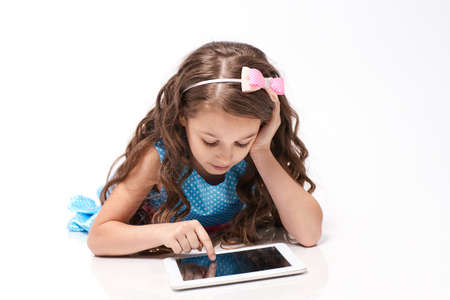 Little girl. Computer tablet. Modern technologies.の写真素材