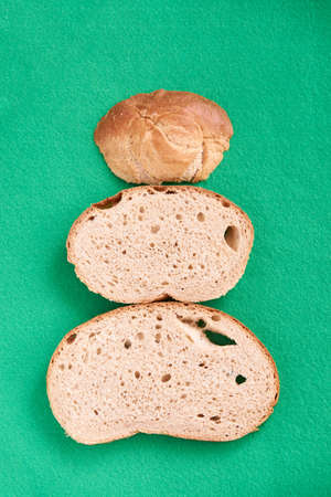 Unusual Christmas tree. Green background. Pieces white bread.の写真素材
