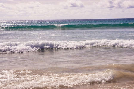 Sea waves. White clouds. Blue water.の写真素材
