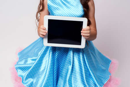 Modern technologies. Computer tablet. Blue dress.の写真素材