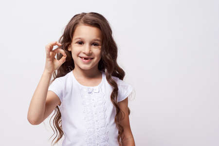 Gesture approval. Little girl. White background.の写真素材