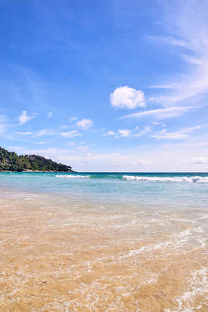 Blue sea. Clear sky. White waves. Green Mountainの写真素材