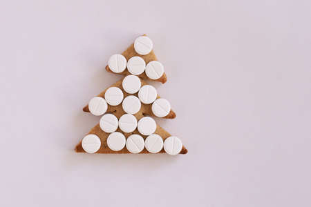 Christmas tree biscuits. Light background. White tablets.の写真素材