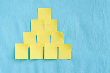Yellow stickers. Unusual tree. Blue background. Bright colors.の写真素材