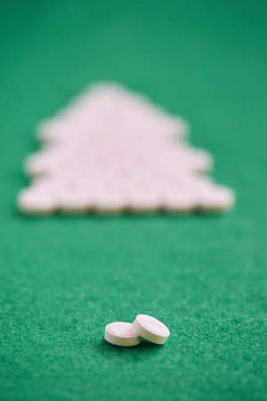 Round white tablets. Green blurred background.の写真素材