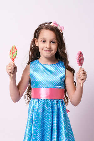 Delicious sweetness. Little girl. Multicolored lollipops.の写真素材