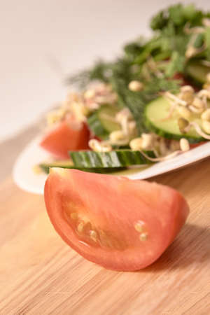 Sprouted beans. Fresh salad. Tomato and cucumber. White plate.の写真素材
