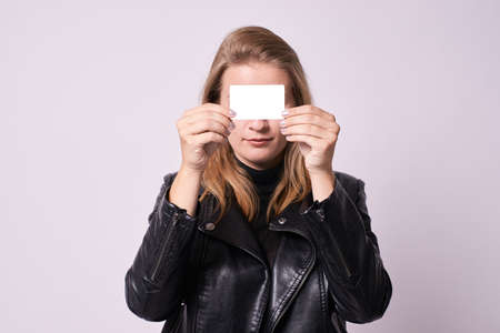 Beautiful girl. White card. Black clothes.の写真素材