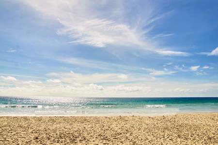 Warm blue sea. White clouds. Light Sand.の写真素材