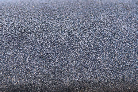 Winter texture. Small gray ice cubes. Dark color.