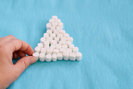 Interesting tree. Blue background. White marshmallows.の写真素材