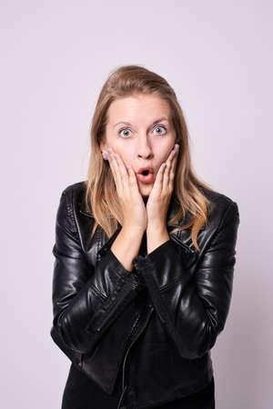 Surprised girl. Black clothes. White background.の写真素材