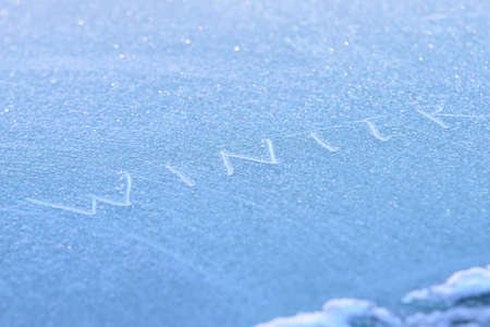 Blue background. White inscription. Brilliant snowflakes.の写真素材