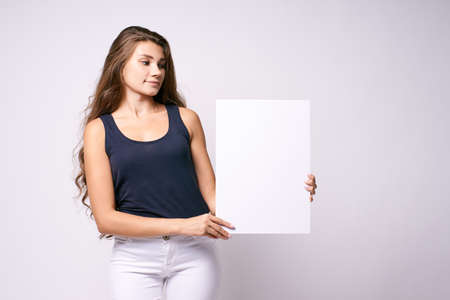 White background. Template. Girl with poster.の写真素材