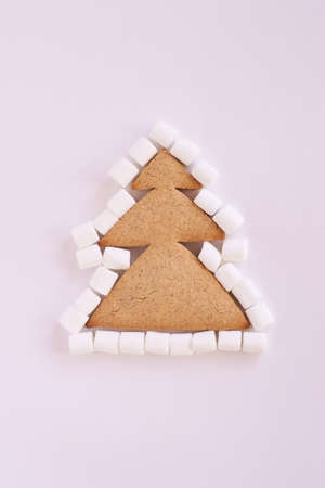 Christmas tree biscuits. White marshmallow. Light background. Delicious dessert.の写真素材