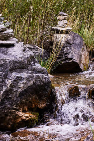 Small stream. Gray stones. Paganism. Vera. Green grass.の写真素材