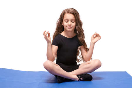 Little girl. Yoga practice. Lotus position.の写真素材
