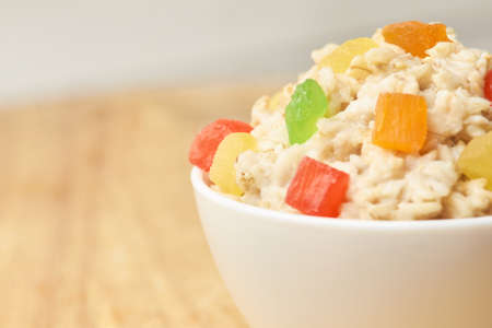 Useful breakfast. Bright colors. Oatmeal with dried fruits.の写真素材
