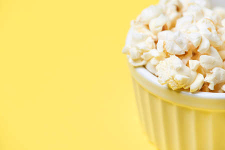 Fresh pop corn. Fried corn. Bright yellow background.の写真素材