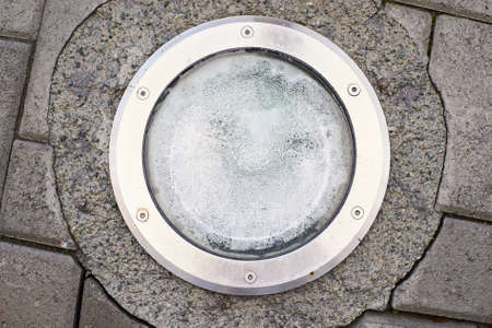 Round lantern on the ground. Gray asphalt.の写真素材