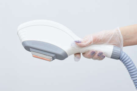 Modern equipment. Laser hair removal. Light background. Personal careの写真素材