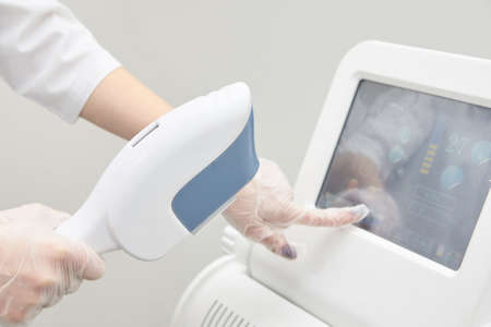 Modern equipment. Laser hair removal. Personal care. Light background.の写真素材