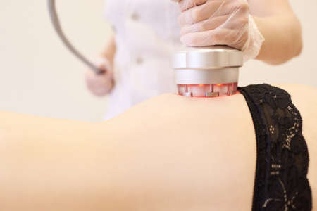 Body cavitation treatment. Ultrasound care to fat reduction. Beauty ultrasonic massage therapy at...