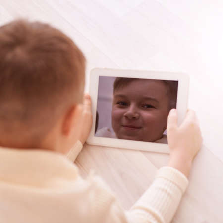 Cute boy. Face on screen. Light background. Horizontal.
