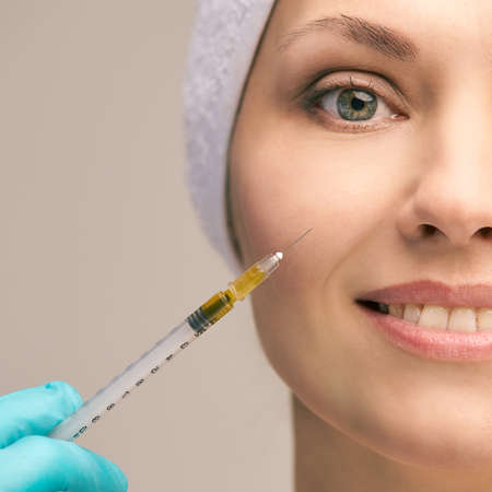 Facial injecting treatment. Skin platelet. Prp rich plasma injection. Beauty woman. Doctor gloves.の写真素材