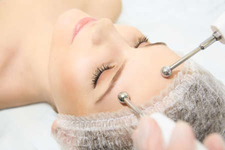 Microcurrent facial dermatology procedure. Model. Aesthetic radiofrequency treatment. Micro current...