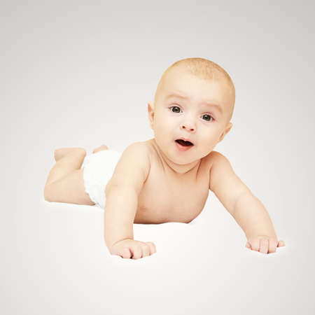 Happy baby toddler. Youth people lying at home. White small child head. Newborn smile.の写真素材