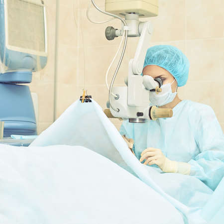 Ophthalmology laser microscope operation. Doctor in clinic. Patient eye treatment. Myopia and cataract removal.の写真素材
