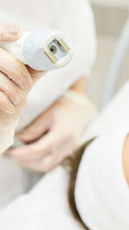 Vacuum face cosmetology equipment. Facial salon cleaning. Youn girl professional skin care. Beauty woman and health device.の写真素材