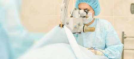 Ophthalmology laser microscope operation. Doctor in clinic. Patient eye treatment. Myopia and...