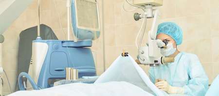 Ophthalmology laser microscope operation. Doctor in clinic. Patient eye treatment. Myopia and cataract removal.の写真素材