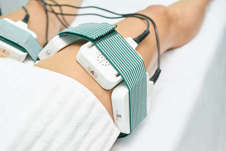 Laser lipo equipment. Cosmetic fat reduce treatment. Woman in medicine salon. Anti cellulite...