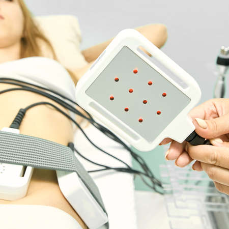 Laser lipo equipment. Cosmetic fat reduce treatment. Woman in medicine salon. Anti cellulite...