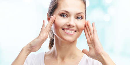 Natural beauty portrait with hands. Cosmetology mature woman face. Cosmetic cream. Skin care. Elegant girl.の写真素材