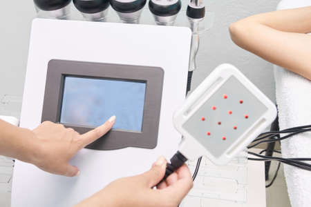 Laser lipo equipment. Cosmetic fat reduce treatment. Woman in medicine salon. Anti cellulite...